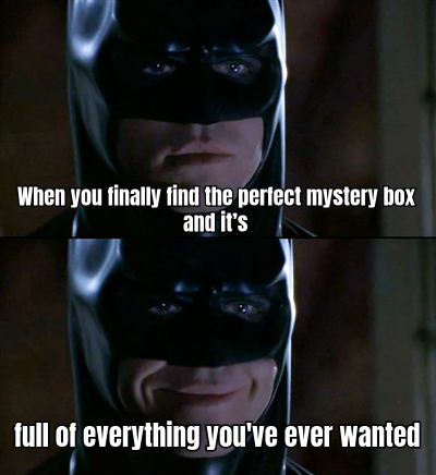 A MAN WITH A HUGE SMILE OPENING A MYSTERY BOX, SURROUNDED BY CONFETTI, WITH THE CAPTION "WHEN YOU FINALLY FIND THE PERFECT MYSTERY BOX AND IT'S LIKE CHRISTMAS MORNING!"